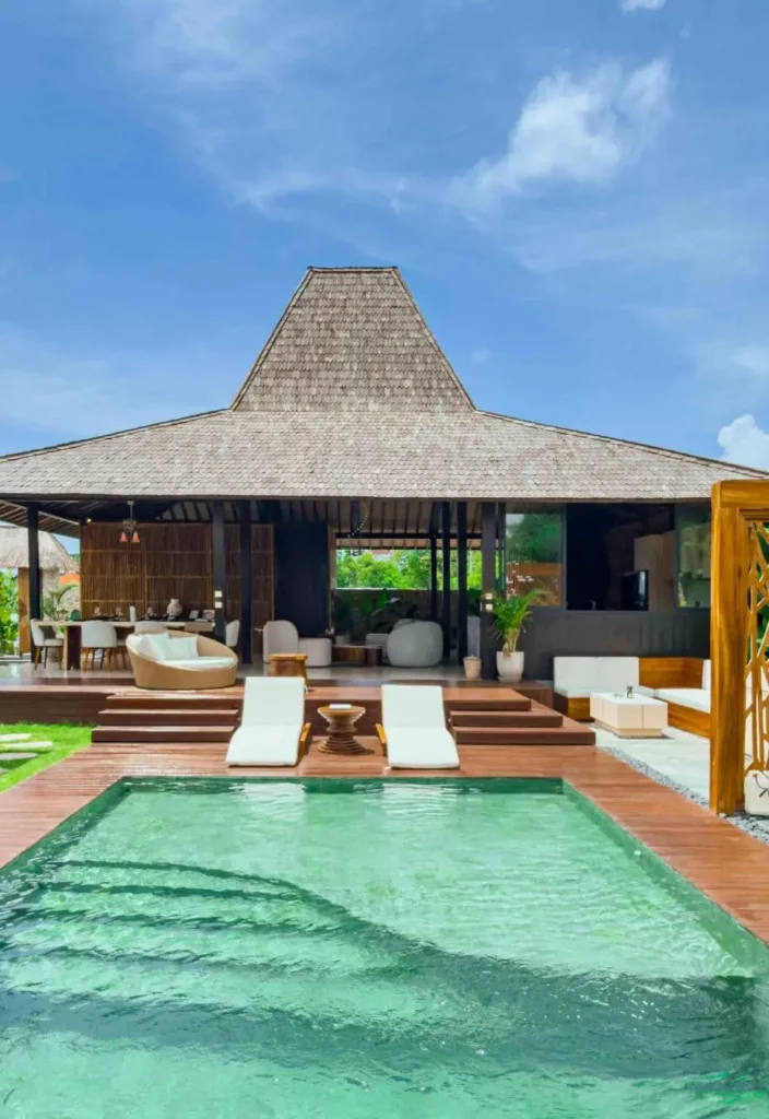 The bathroom features a refined vanity with handcrafted stone sinks, a large mirror and carefully selected amenities, reflecting the villa’s attention to detail and comfort.